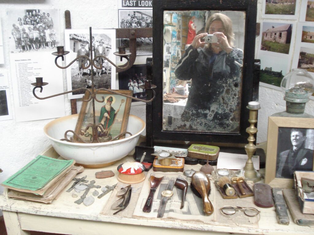 Anthropologist taking photograph in mirror in island museum